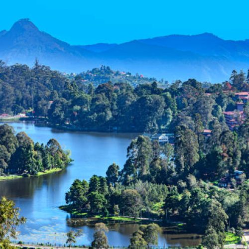 Kodaikanal, India - A high angle view of  Kodaikanal Lake on the Palani Hills, in the South Indian State of Tamil Nadu located at about 7000 feet above sea level; In the far background is the peak known locally as Perumal Malai. The colonial town and hill station, was set up by the British when they were in India. The lake was set up by British engineers in 1853. Image shot in the morning sunlight. Horizontal format; no people.