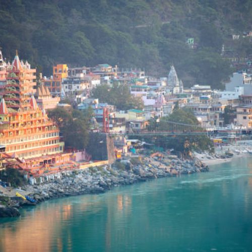 Spectacular view of the Lakshman Temple bathed by the sacred river Ganges at sunset. Trayambakeshwar is one of the important holy shrines in Rishikesh, Uttarakhand, India.